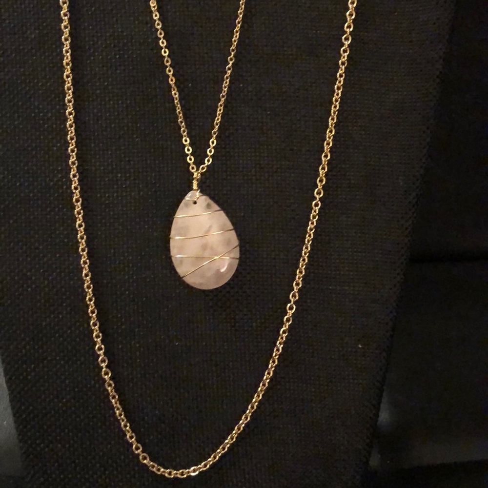 Necklace with light pink pendant.